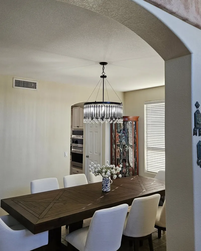 Dining room with a new crystal chandelier centered over the table